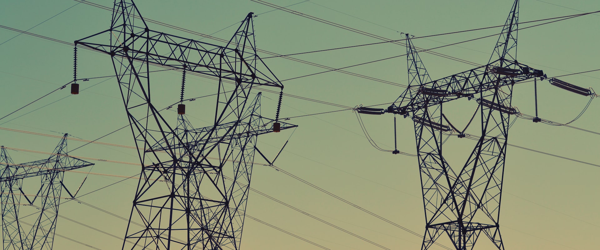 High-voltage transmission lines crossing open countryside.