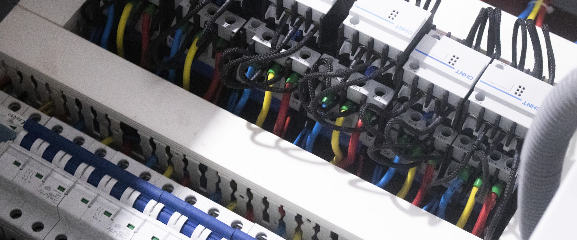 An electrician working on a commercial distribution board.