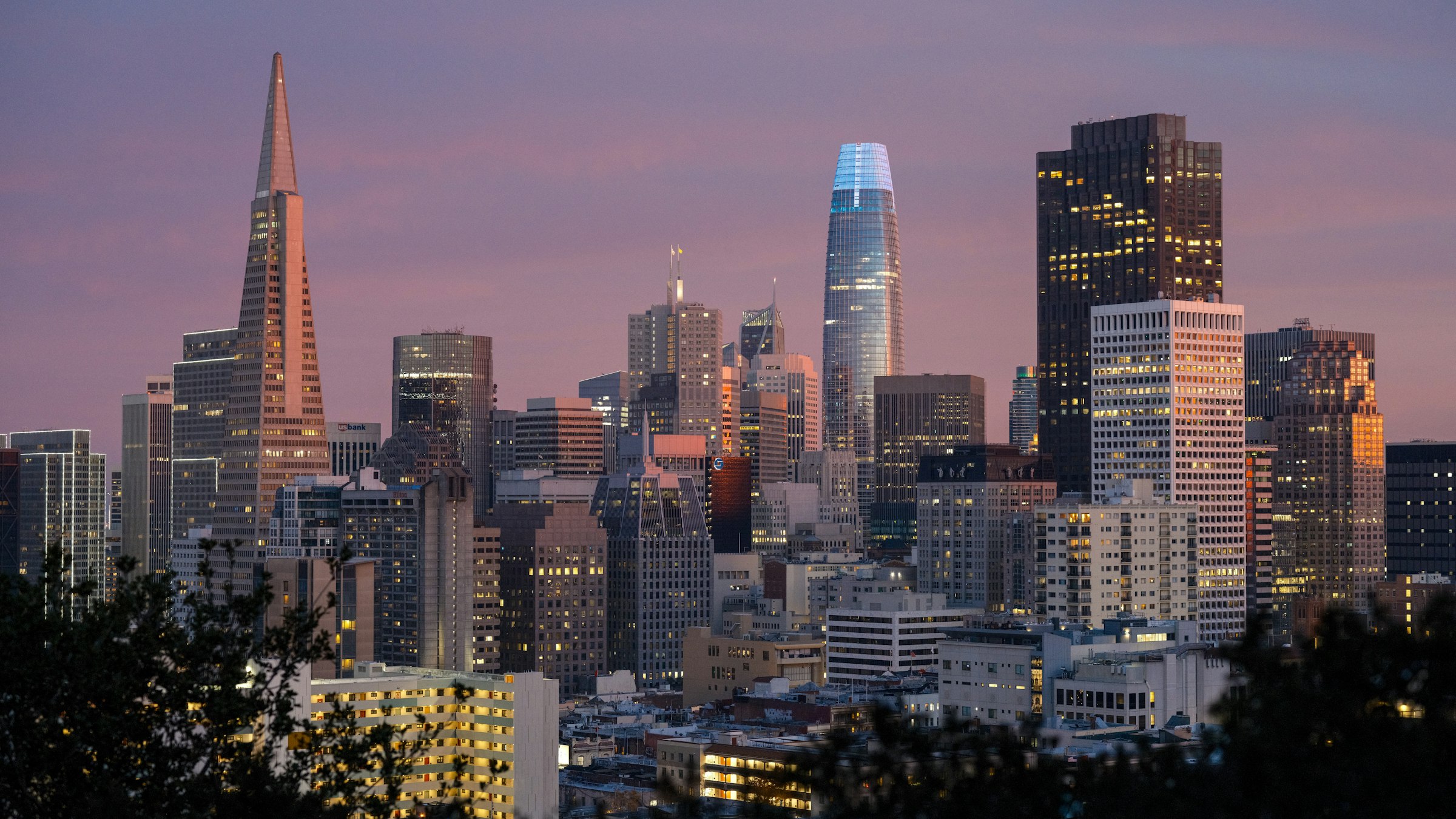 City skyline glowing at dusk.